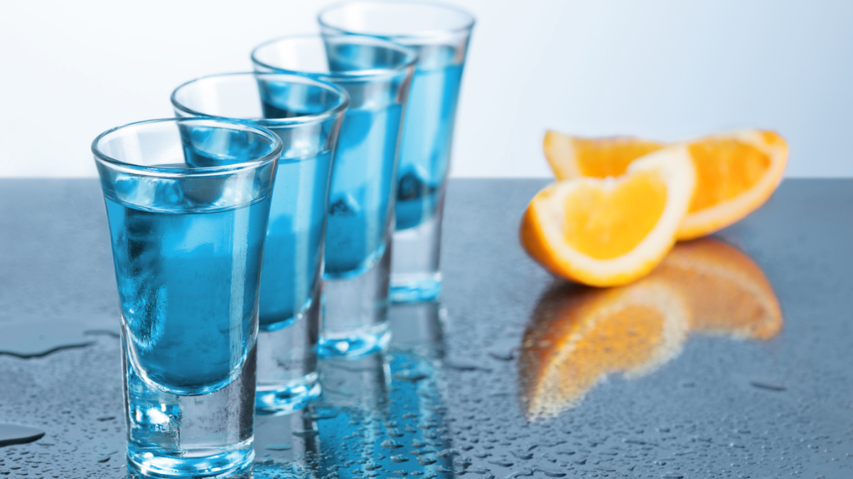 Vodka shots with slices of orange.